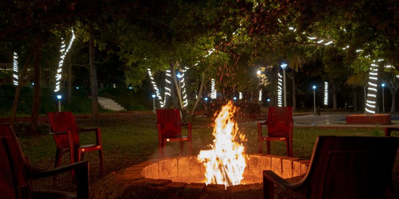 Resort with bonfire and rain dance